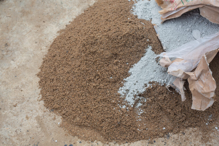 construction technicians are mixing cement, stone, sand for construction.
